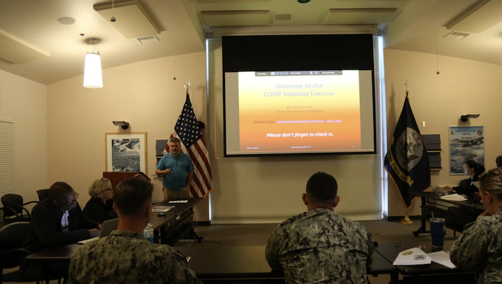 Military personnel addresses the Cyber Eclipse Continuity of Operations tabletop exercise