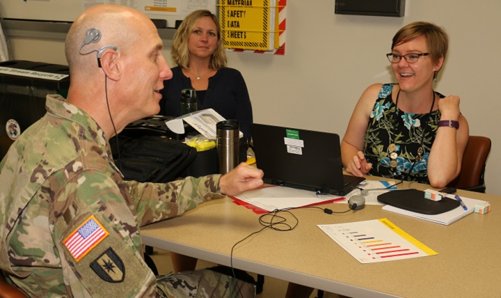 Link to Photo: Dr. Elizabeth Searing (right) makes initial adjustments via a computer to Lt. Col. James Morrison's cochlear implant. Dr. April Luxner, an audiologist with Cochlear Corporation, was on hand to witness Morrison's reactions to hearing with his right ear after 12 years of deafness. (U.S. Army photo by Jeff Troth)
