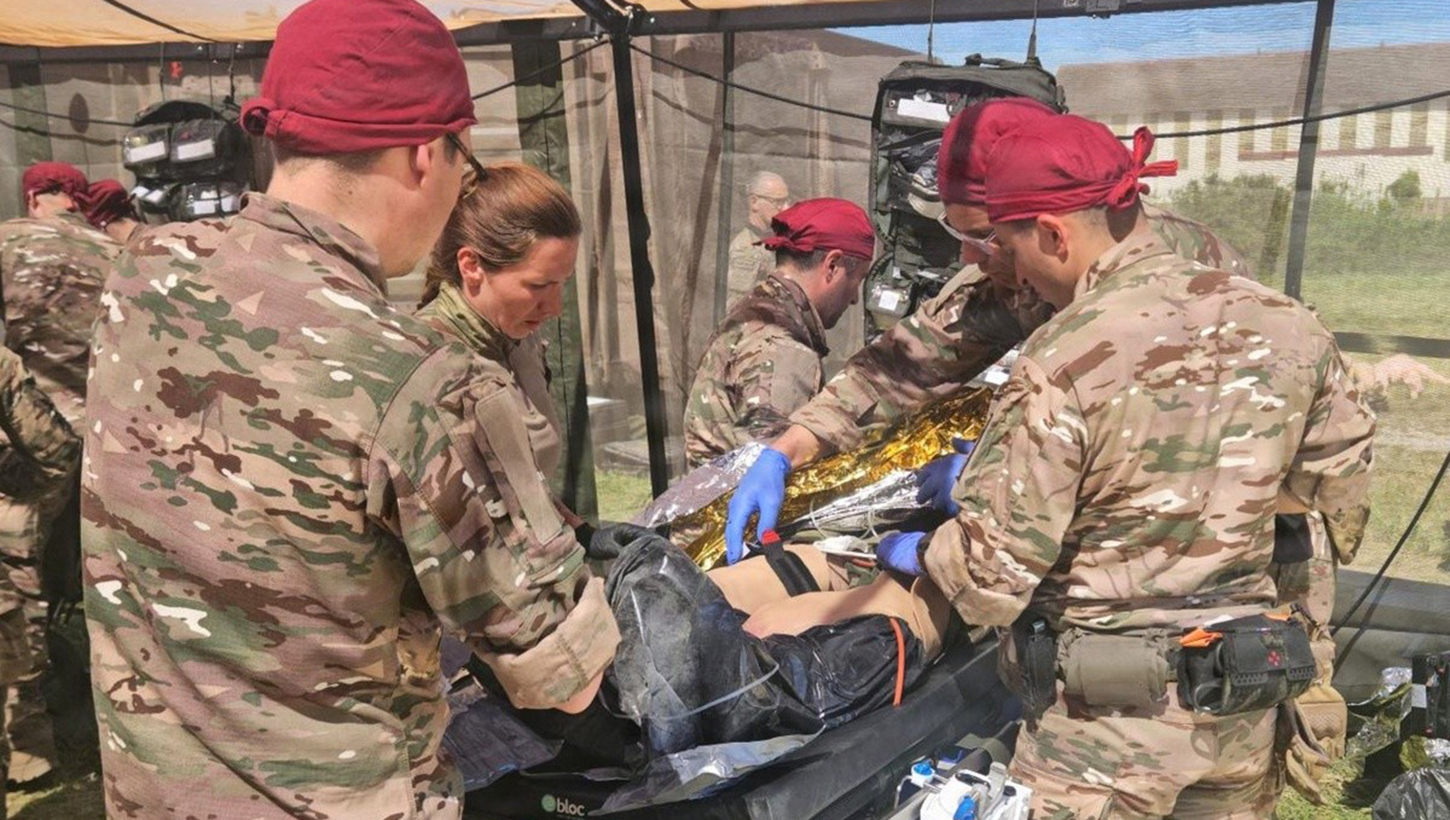 French military medical personnel treat a simulated casualty