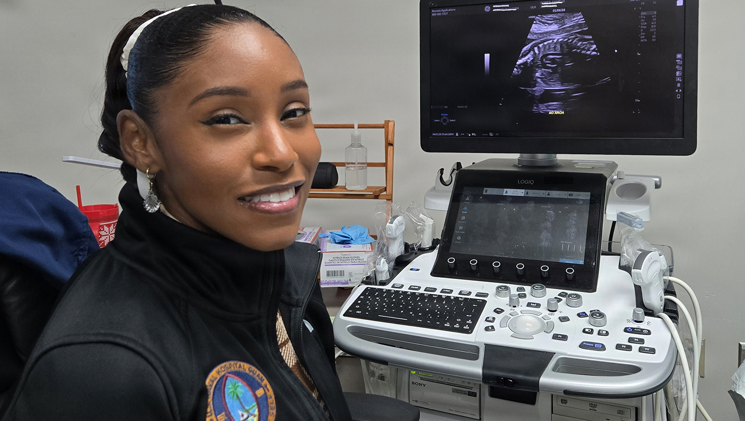 Hospital Corpsman 2nd Class Arlesha Cooper-Revish poses for a photo in front of an ultrasound machine