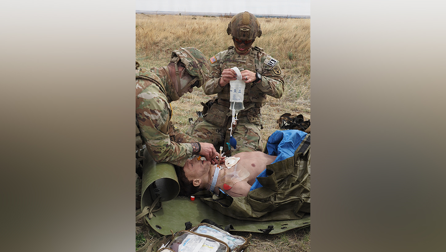 1st Lt. Brendan Killian, left, a 66H Medical-Surgical Nurse, and Staff Sgt. John Baek, a 68W Combat Medic, perform simulated tactical combat casualty care on a mannequin