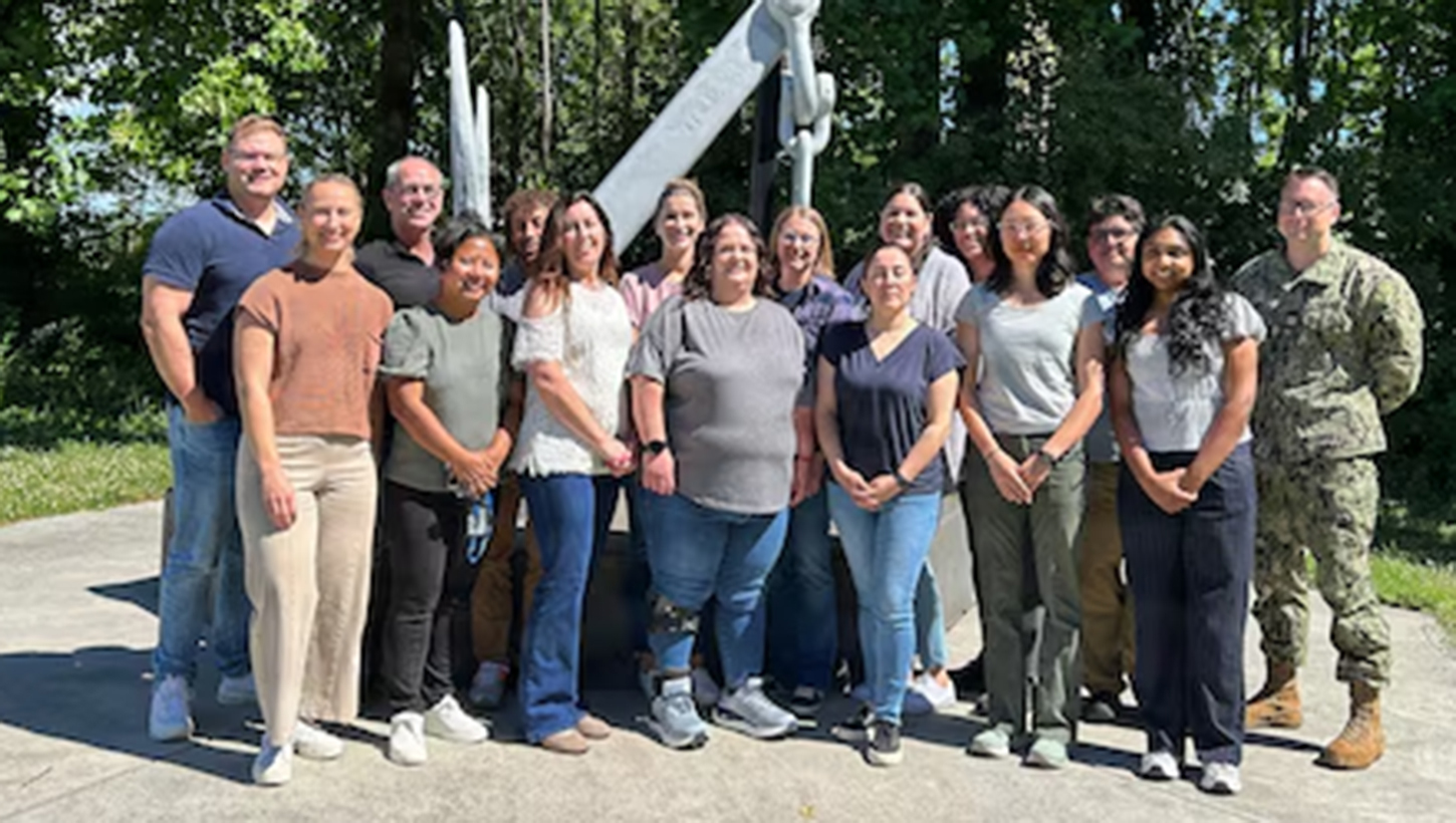 Kimberly Bishop-Lilly (first row, third from left) poses for a photo with members of Naval Medical Research Command’s (NMRC) Genomics & Bioinformatics Department. 
