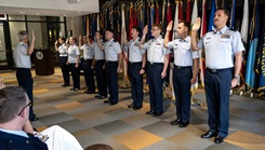 U.S. Air Force and U.S. Coast Guard service members take the oath of office