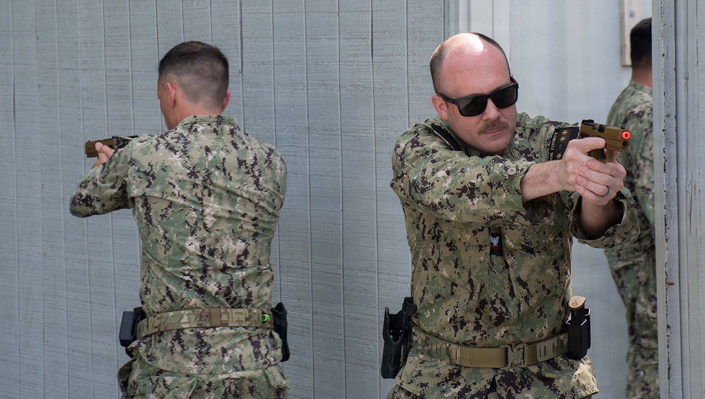 Hospital Corpsman 2nd Class Nicholas Moubarak, assigned to Expeditionary Resuscitative Surgical System (ERSS) Three, and Lt. Cmdr. Derrick O'Neal, assigned to the Expeditionary Medical Facility (EMF) Alpha, conduct close quarter combat (CQC) training