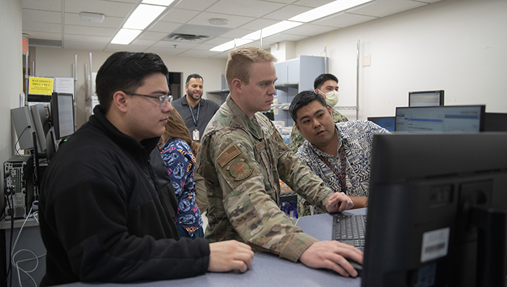 Image of military personnel at computer monitor.