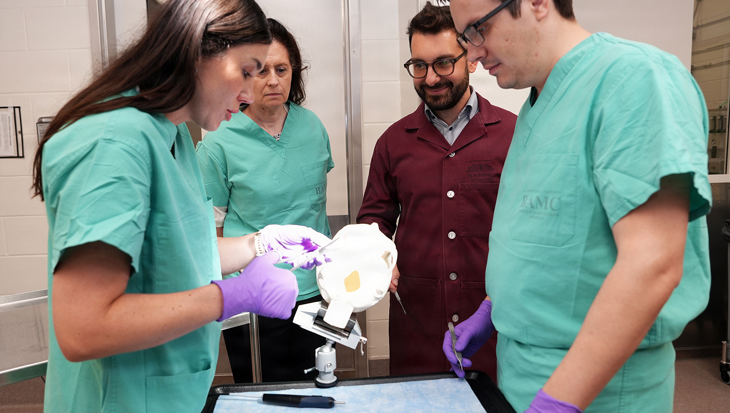 Janaina Bortolatto, vice president of Clinical Operations for Cohesys, prepares BoneTape for application on an artificial skull during a demonstration of new ultrasonic applicator for BoneTape resorbable fracture stabilization implant