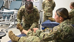 U.S. Air Force Senior Airman JeanAnn Kasune, aerospace medical technician with the 439th Aeromedical Staging Squadron, provides medical aid to a basic cadet at the U.S. Air Force Academy’s Jacks Valley medical clinic in Colorado Springs
