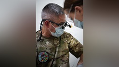 U.S. Air Force Lt. Col. Matthew Heineman, 434th Aerospace Medicine Squadron dentist, examines a patient 
