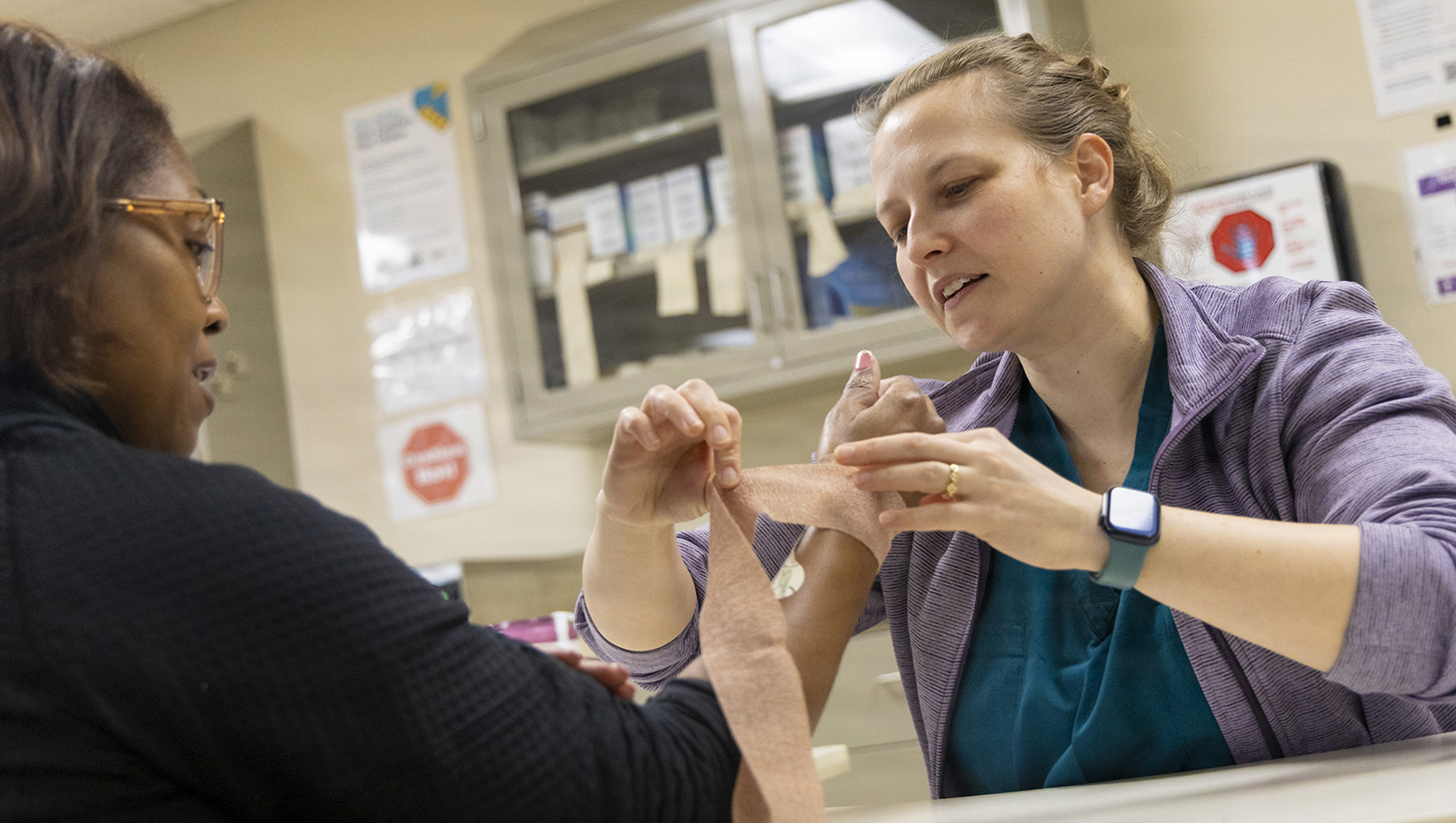 Image of Rachael Smith, a certified occupational therapist assistant, works with a patient at the Outpatient Occupational Therapy Clinic.