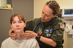 A squadron flight surgeon performs a neck and throat examination to check for conditions such as enlarged lymph nodes, thyroid swelling, and circulatory problems. U.S. Air Force photo by Daniel Martinez.