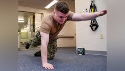 Hospital Corpsman Conor Tucker, assigned to Navy Medicine Readiness and Training Command, who works in the naval hospital’s physical therapy department, demonstrates physical therapy moves