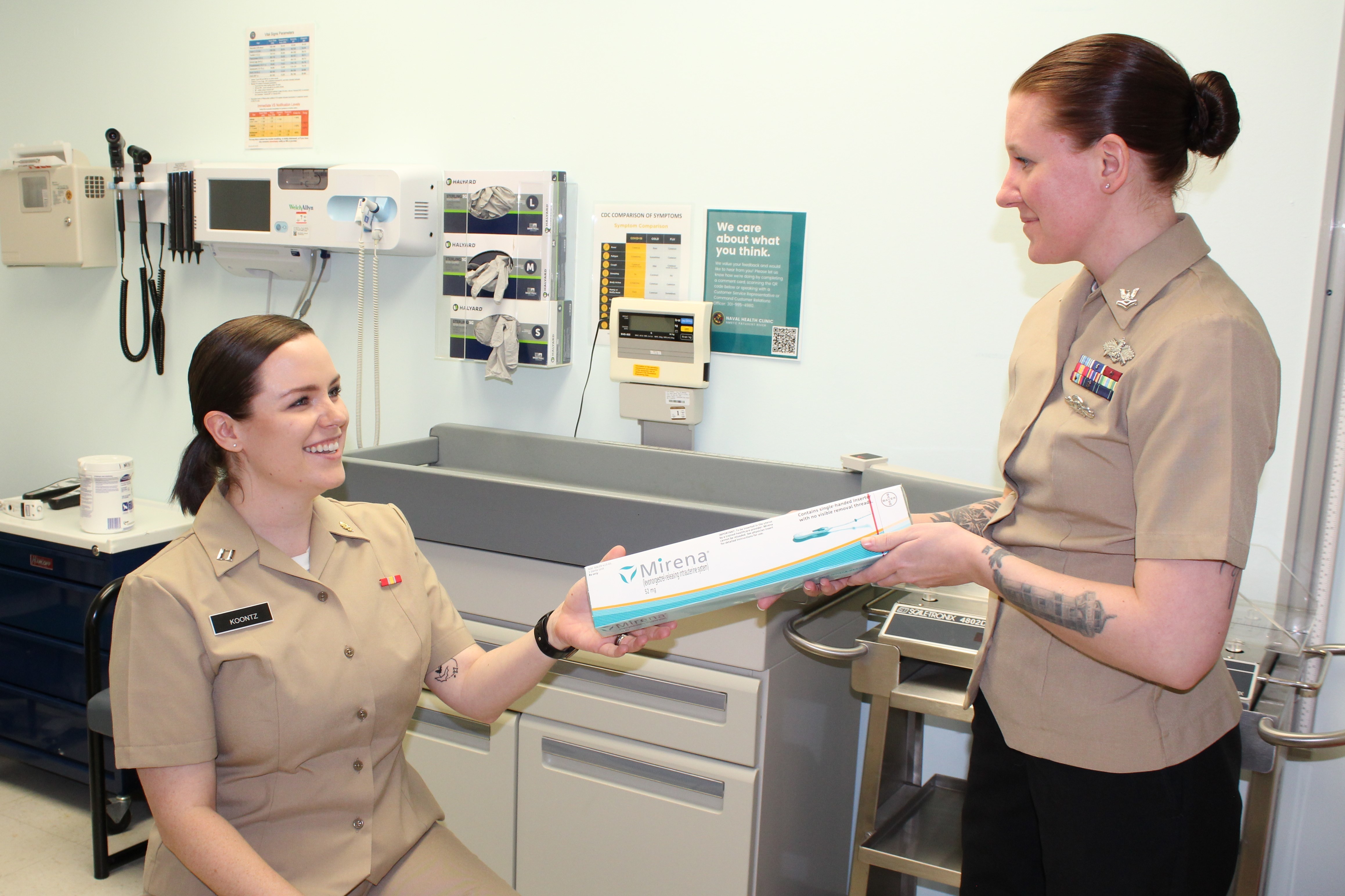 Hospital Corpsman 2nd Class Victoria McPhall hands Lt. Laken Koontz an intrauterine device at Naval Health Clinic Patuxent River. IUDs are one of the many birth control options offered during the clinic’s walk-in contraceptive clinic every Wednesday from 1-2 p.m. The Defense Health Agency’s Women’s Health Clinical Management team faced an aggressive three-month deadline to roll out new Walk-in Contraceptive Services walk-in contraceptive services at military hospital and clinics across the Military Health System. (Photo: Photo by Kathy Hieatt, Naval Health Clinic Patuxent River, Maryland)