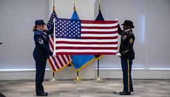 The Defense Health Agency’s 9/11 remembrance ceremony at Defense Health Headquarters in Falls Church, Virginia, featured a flag-folding ceremony and a reflection from retired U.S. Army Col. (Dr.) James Geiling, who served as director of the DiLorenzo Pentagon Health Clinic on the day of the attacks.. Preparing to fold the U.S. flag are U.S. Air Force Master Sgt. Jillian Kozub with DHA Health Informatics and U.S. Army Sgt. First Class Akela Clark with DHA Health Care Operations, dental section.  (Photo: Robert Hammer, MHS Communications)