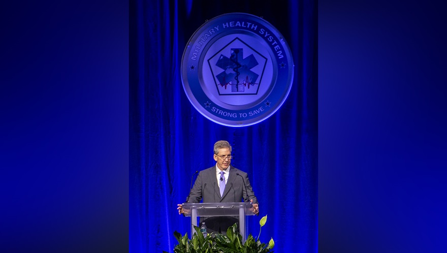 Top military health official kicks off annual symposium, encourages collaboration to ‘transform research into better care for those who serve’