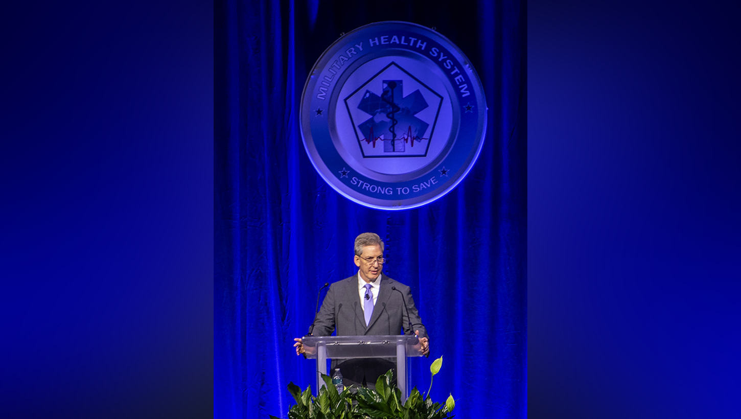 Image of Top military health official kicks off annual symposium, encourages collaboration to ‘transform research into better care for those who serve’.