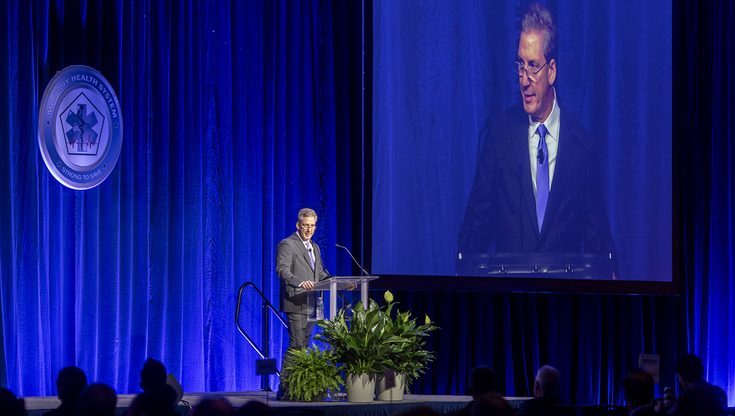 Image of Top military health official kicks off annual symposium, encourages collaboration to ‘transform research into better care for those who serve’.