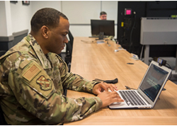 photo of solider working on a computer