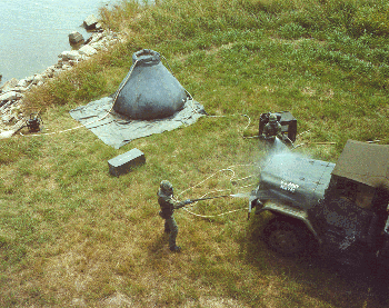 Figure 19. Soldiers in training use a SenatorTM to decontaminate a vehicle