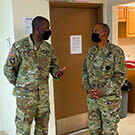 Two military men standing and talking