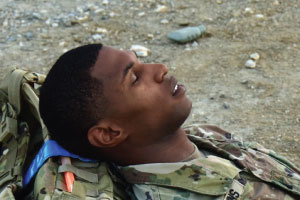 Photo of service member sleeping in the field