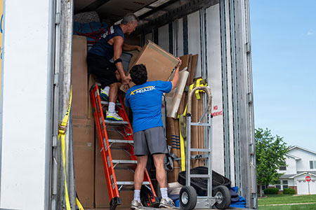Photo of two people loading a moving truck