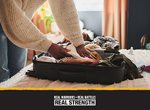 photo of arms packing a suitcase on a bed. real warriors logo at the bottom. 