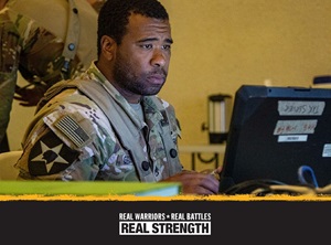 Photo of service member looking at computer screen with Real Warriors logo on the bottom