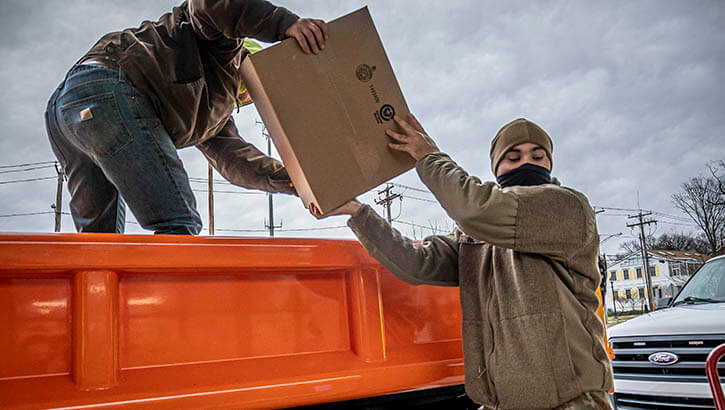Image of A Soldier assigned to the Connecticut National Guard helps load a shipment of at-home COVID-19 testing kits into a truck at a regional distribution point in North Haven, Connecticut, Jan. 3, 2022. These kits were picked up by representatives from local towns and municipalities to be handed out to their communities. Click to open a larger version of the image.