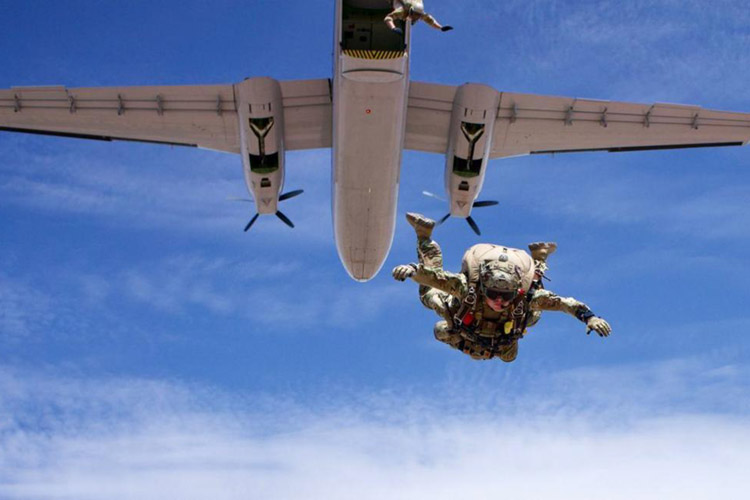Image of U.S. Air Force Capt. Hopkins, 351st Special Warfare Training Squadron, Instructor Flight commander and Chief Combat Rescue Officer (CRO) instructor, conducts a military free fall equipment jump from a DHC-4 Caribou aircraft in Coolidge, Arizona, July 17, 2021. Hopkins is recognized as the 2020 USAF Special Warfare Instructor Company Grade Officer of the Year for his outstanding achievement from January 1 to December 31, 2020.
