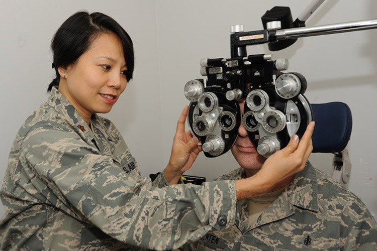 Ophthamologist Air Force Maj. Thuy Tran evaluates a patient during an eye exam. (U.S. Air Force photo by Tech. Sgt. John Hughel)