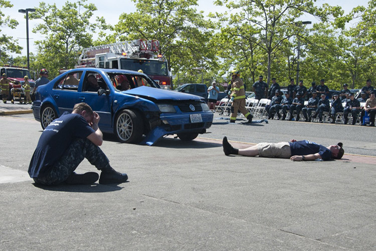 Image of Sailors simulate a drunk driving accident during a Keep What You've Earned fair on Naval Base Kitsap Bangor. The fair encourages responsible alcohol use by celebrating the achievements in the sailors' Navy careers and actively engages sailors as advocates for responsible drinking. (U.S. Navy photo by Mass Communication Specialist 3rd Class Chris Brown).
