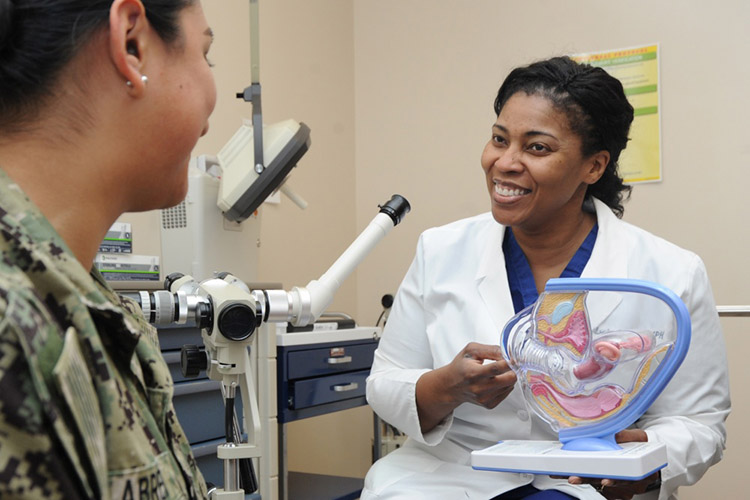 Lt. Cmdr. Leslye Green, staff obstetrician and gynecologist, Naval Hospital Pensacola (NHP), uses a model to discuss cervical cancer with a patient at NHP. According to the Centers for Disease Control and Prevention (CDC), cervical cancer is highly preventable because screening tests for cervical cancer and vaccines to protect against human papillomavirus (HPV), which is the main cause of cervical cancer, are readily available. Cervical cancer is highly treatable and associated with long survival and good quality of life when it is detected early. (U.S. Navy photo by Mass Communication Specialist 1st Class Brannon Deugan)
