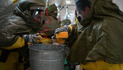 Air National Guard medical personnel decontaminate a simulated patient