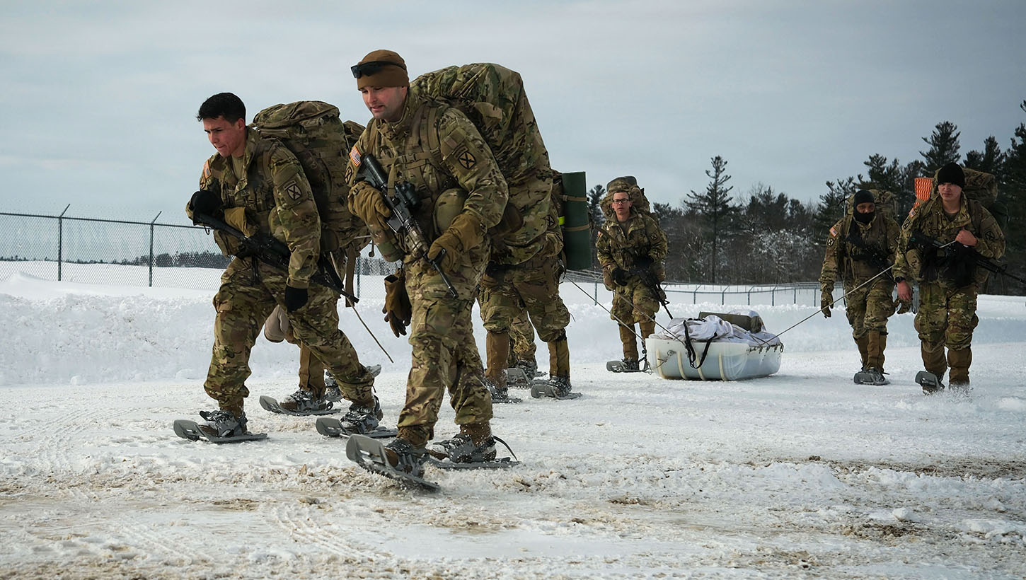 Soldiers assigned to the 2nd Brigade, 10th Mountain Division, arrive at the radio station during an annual winter competition