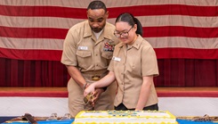 Master Chief Hospital Corpsman Louis Raiford and Hospitalman Apprentice Winnie Li cut a cake