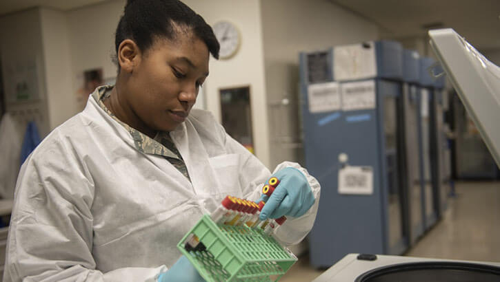 Image of U.S. Air Force Staff Sgt. Ashley Solomon, 18th Medical Support Squadron NCO in charge of microbiology, unloads blood samples from a centrifuge at Kadena Air Base, Japan, Jan. 31, 2019. (Photo: Tech. Sgt. Matthew B. Fredericks, U.S. Air Force). Click to open a larger version of the image.