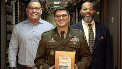 Alejandro Gonzalez, Information Management Division chief, Army Lt. Col. Bruce Barnes, chief information officer, and Walter Walsh, deputy chief information officer, show the 2025 Digital Health Most Wired award