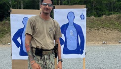 Master-at-Arms 2nd Class Gurjoban Singh, command master-at-arms assigned to Navy Medicine Readiness and Training Command (NMRTC) Twentynine Palms, poses with a target following a live-fire exercise
