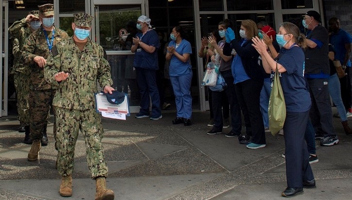 Healthcare workers applauding departing soldiers
