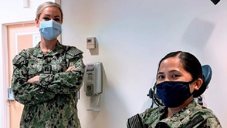 Image of two military personnel wearing masks