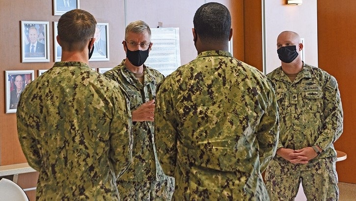 Image of Four military personnel in uniform, wearing masks. Click to open a larger version of the image.