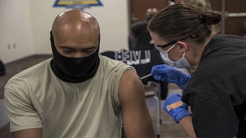 Air Force personnel getting the COVID vaccine shot in his left arm