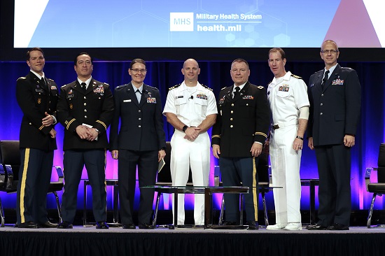 MHSRS plenary panelists after their session.  Panel members from left are:  moderator Air Force Lt. Col. Brian Beldowicz; Army Lt. Col. Phu “Chuck” Nguyen; Air Force Col. Stacy Shackelford; Navy Cdr. Matthew Bradley; Army Col. Andrew Cap; Navy Capt. Eric Elster; and Air Force Col. Todd Rasmussen. (MHS photo)