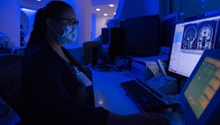 Military medical personnel looking at a patient's brain scan