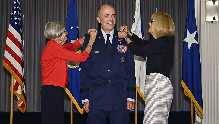 Lt. Gen. Robert Miller has his new rank pinned on by his wife and mother-in-law