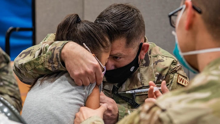 Image of A parent comforts his child while she receives a pediatric dose of the COVID-19 vaccine at Kadena Air Base, Japan, Jan. 28, 2022. (Photo: Airman 1st Class Anna Nolte, 18th Wing Public Affairs).