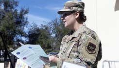 Military personnel holding papers