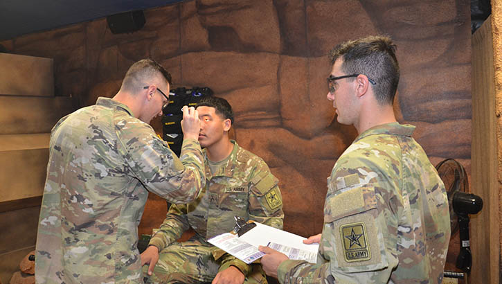 Image of Pfc. Thomas Icenogle, a student in the Army’s Combat Medic Specialist Training Program at the Medical Education and Training Campus on Joint Base San Antonio-Fort Sam Houston, Texas, conducts a Military Acute Concussion Evaluation 2 (MACE 2) on Pvt. Alejandro Leija, while Pvt. Dominic Dubois refers to the MACE 2 card. (Photo: Lisa Braun, Medical Education and Training Campus Public Affairs). Click to open a larger version of the image.