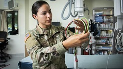 Military medical personnel in BAMC trauma bay