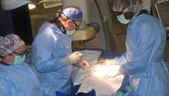 Military medical personnel performing surgery